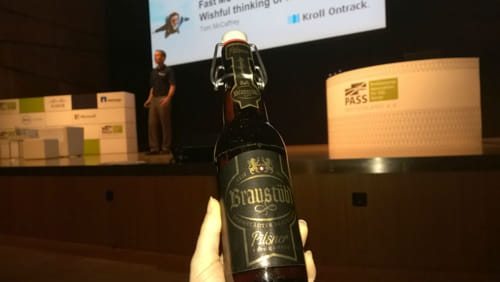 Cathrine holding a bottle of beer at SQLKonferenz 2015.