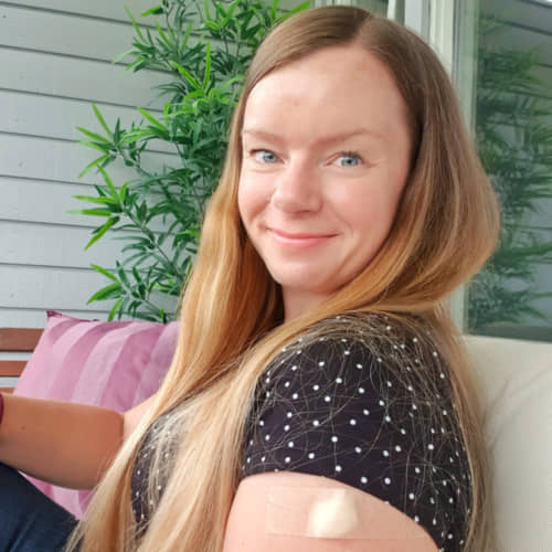 Cathrine Wilhelmsen smiling with a bandaid on her arm.
