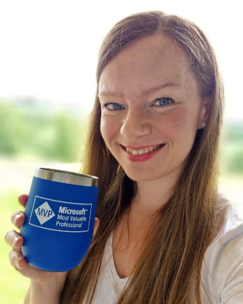 Cathrine Wilhelmsen holding a Microsoft MVP 2023 mug.