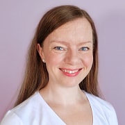 Cathrine Wilhelmsen smiling and wearing a pink t-shirt that says Code Like A Girl